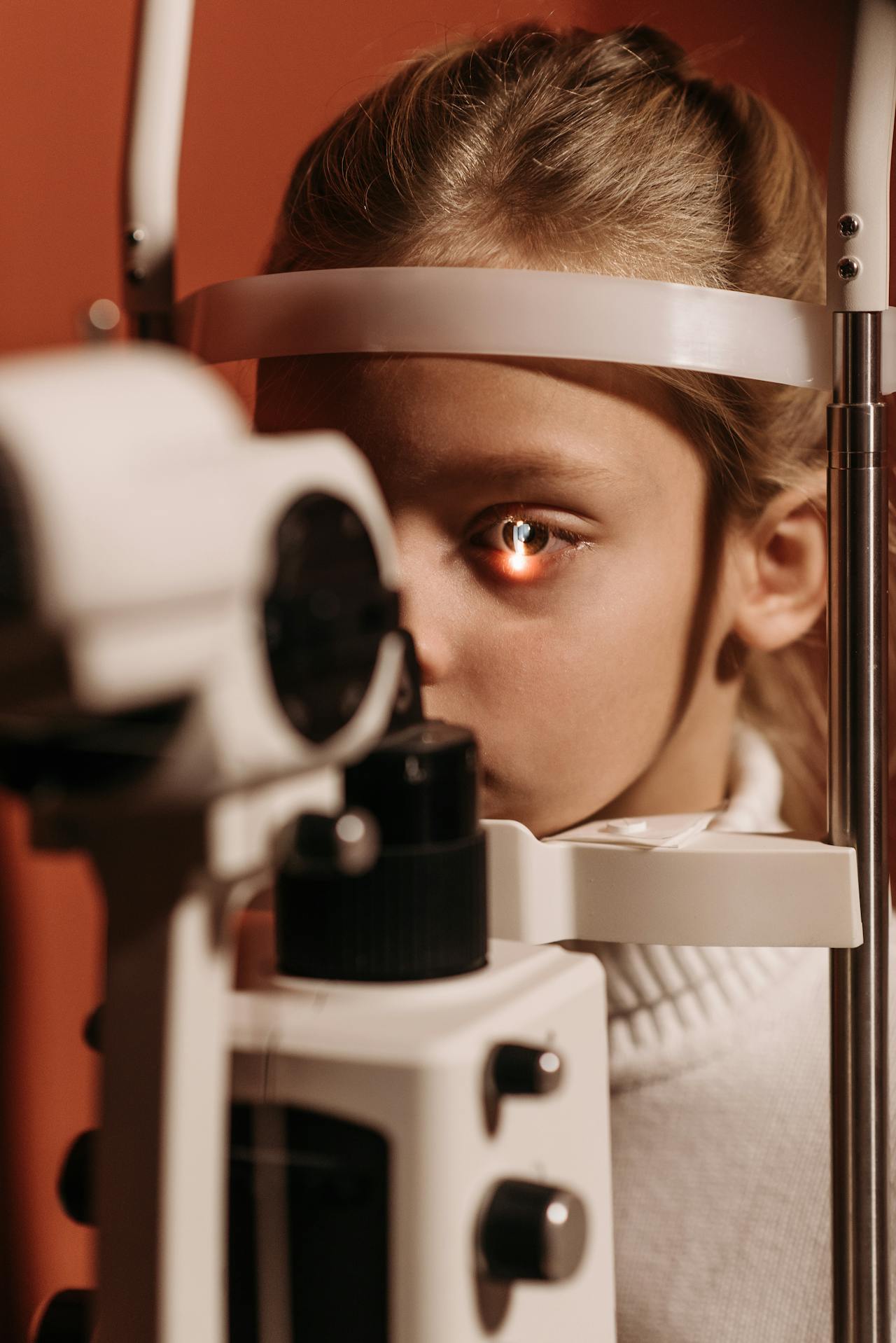 Slit lamp eye examination close-up showing the catchlight reflection — the diagnostic precision behind every Ortho-K fitting at Infinite Vision Eye Care