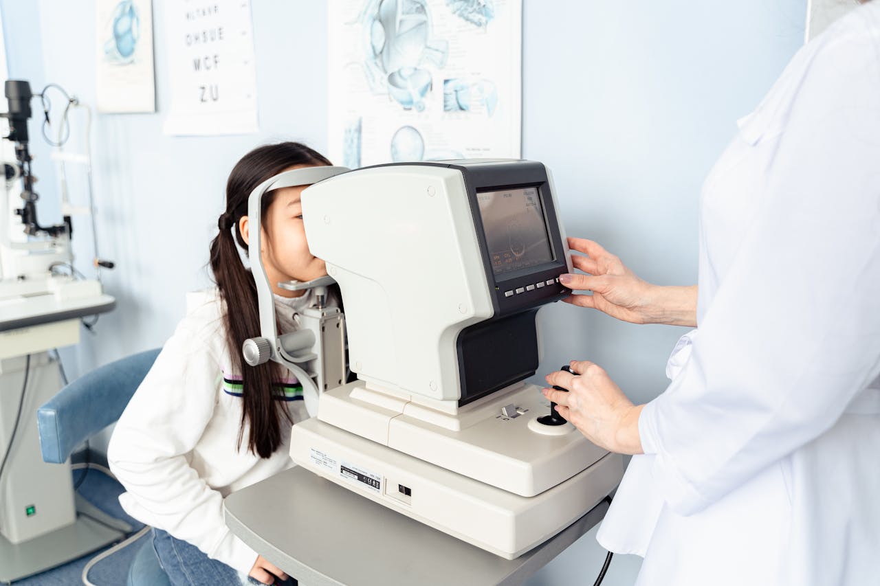 Pediatric eye examination using an autorefractor at a modern optometry clinic — diagnostic precision for Ortho-K candidates at Infinite Vision Eye Care